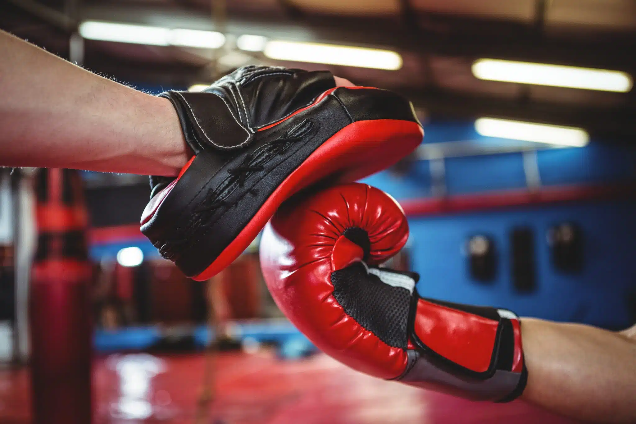 Boxing Sport Store -Boxing Sport Store female boxer practicing with trainer scaled.jpg